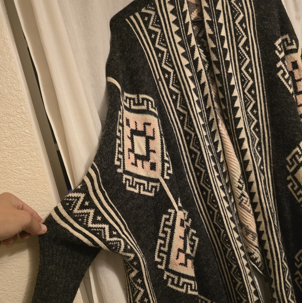 Reborn ruana poncho with tribal print, size large.